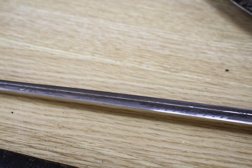 A cut steel dress sword by Ede & Ravenscroft of London and two brass hilted dress swords